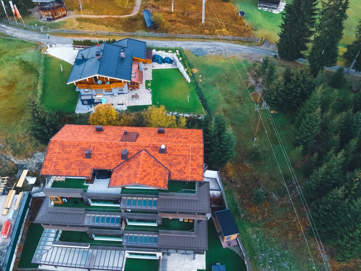 Aerial photo with drone of real estate roof in the Alps